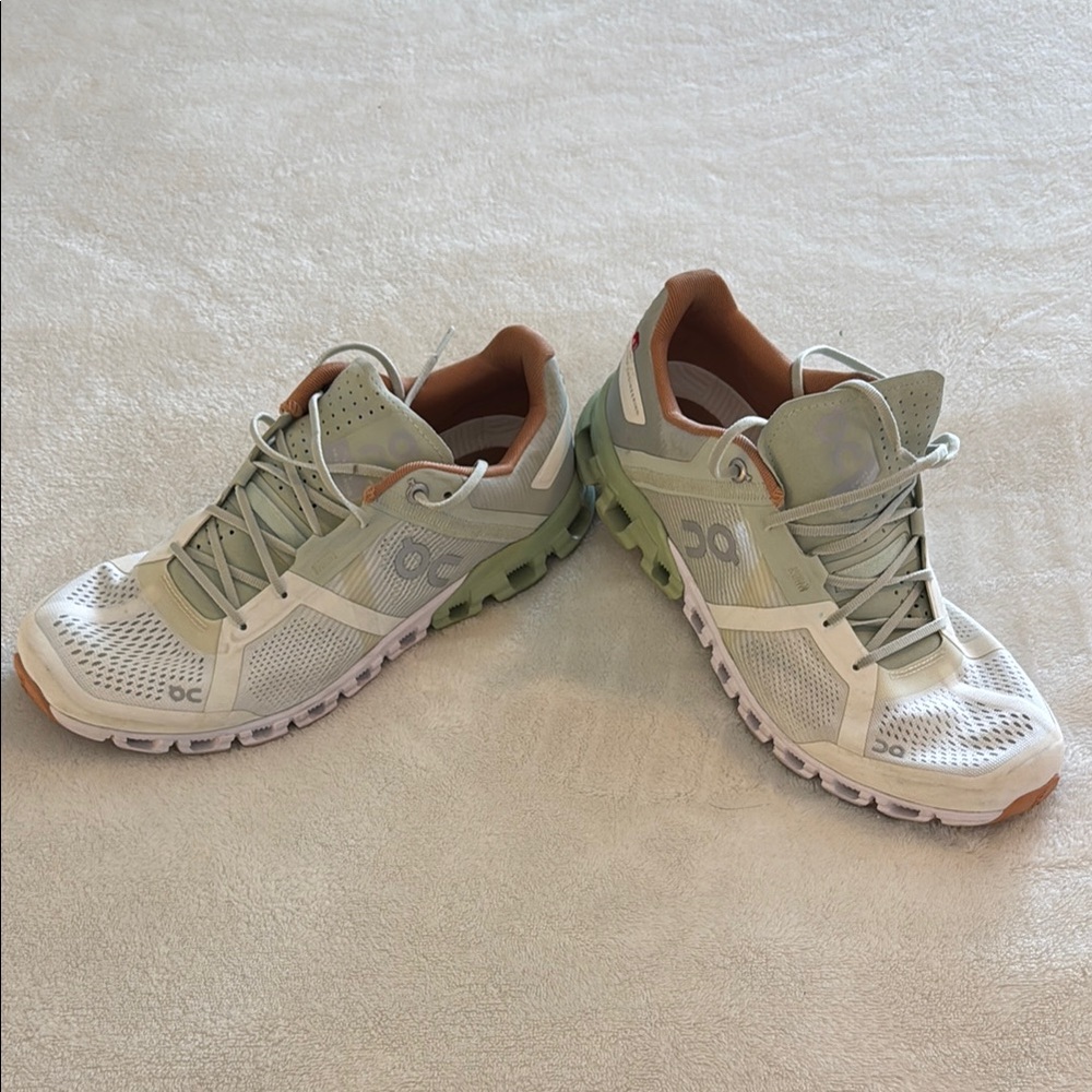 On Running Cream and Green Athletic Shoes